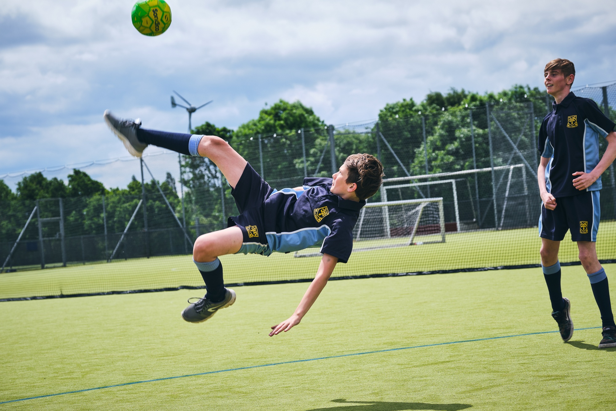 student doing an overhead kick in football